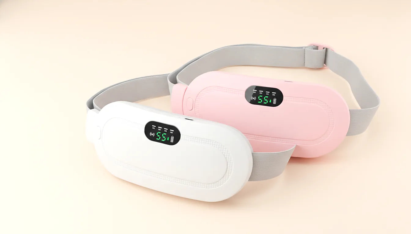 Both colourways side by side on a warm cream background: the white pad in front, the pink one behind, each with its display lit green.